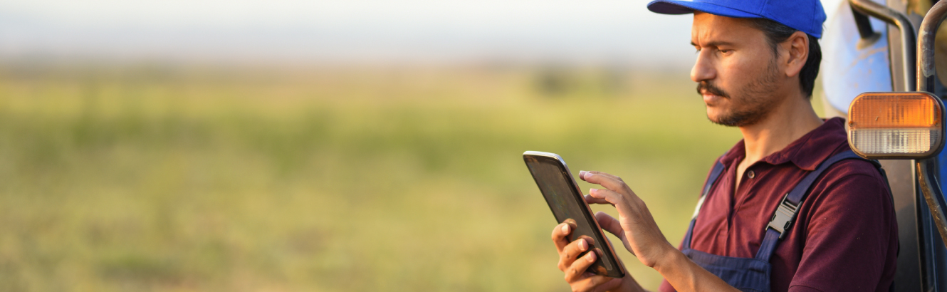 farmer using tablet device in field